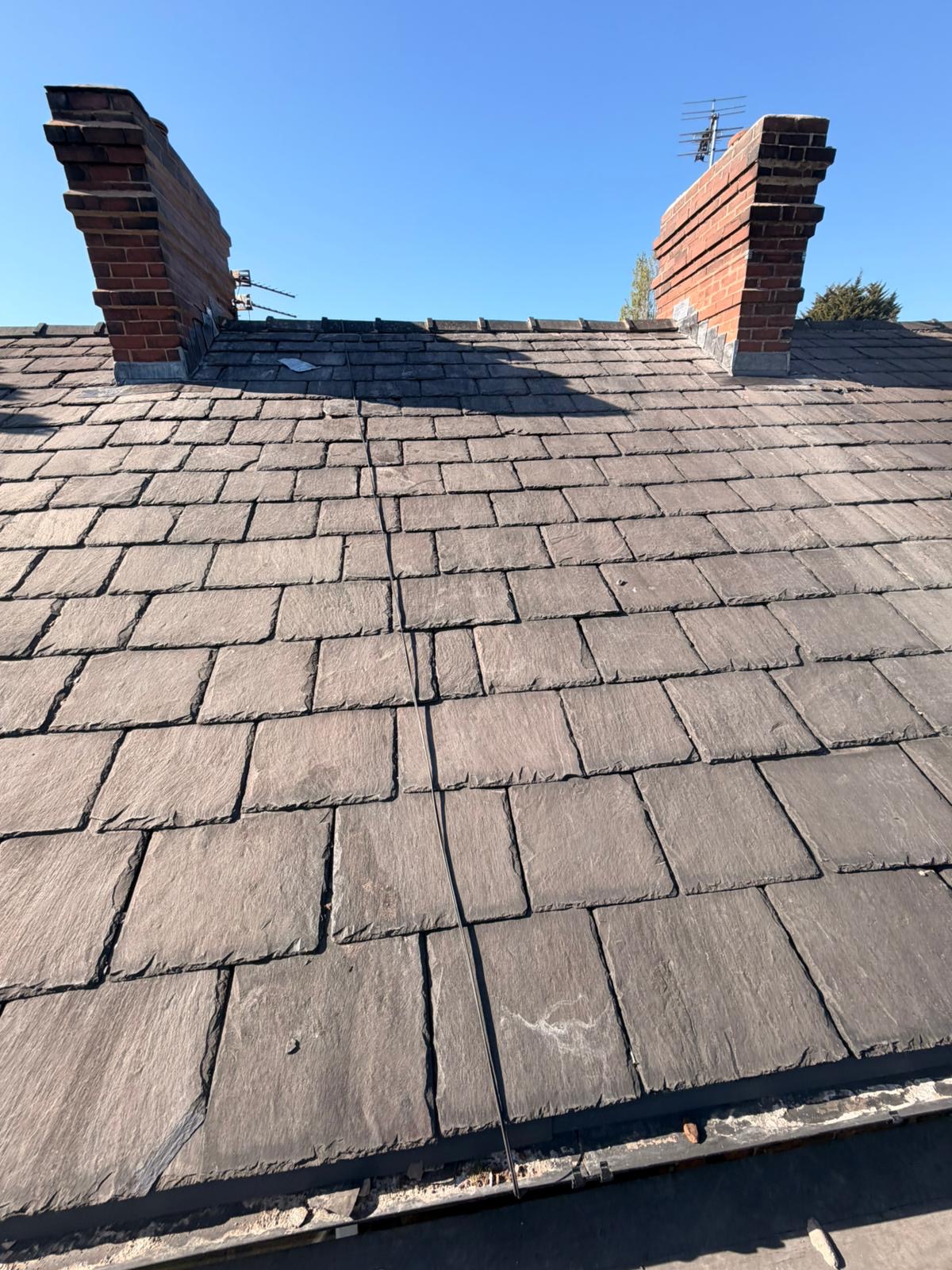 Existing slate roof between twin chimneys