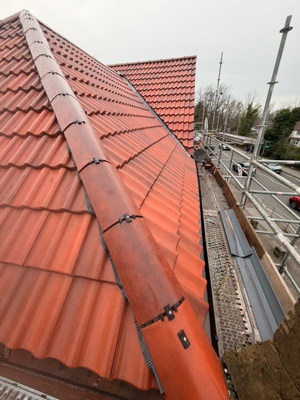 Fresh red tile roof with dry ridge system