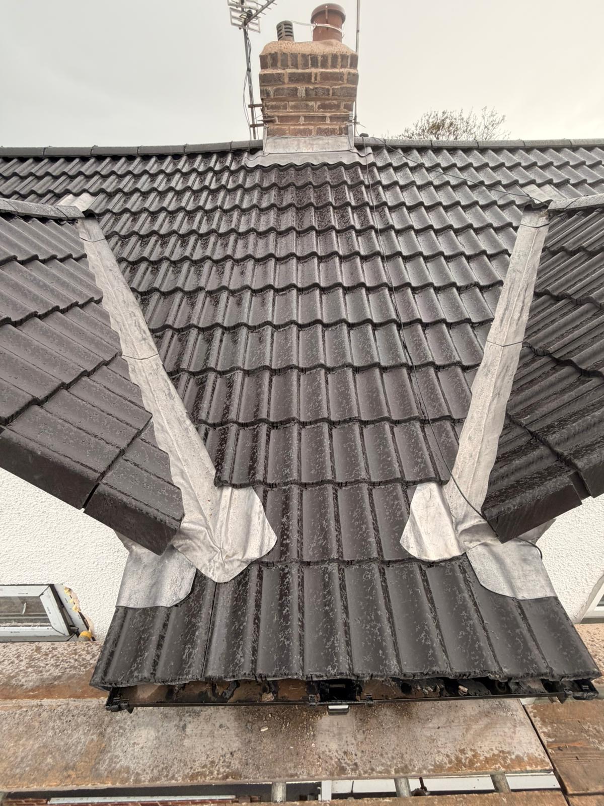 Re-tiled grey roof with new lead valleys