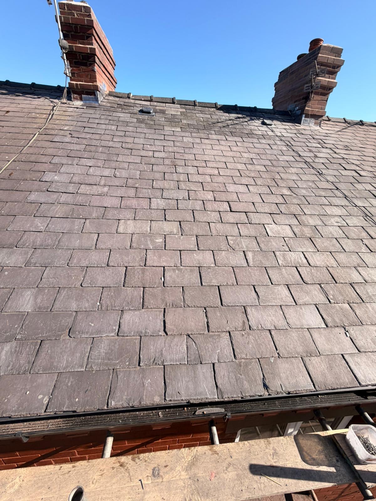 Slate roof with twin chimneys repaired