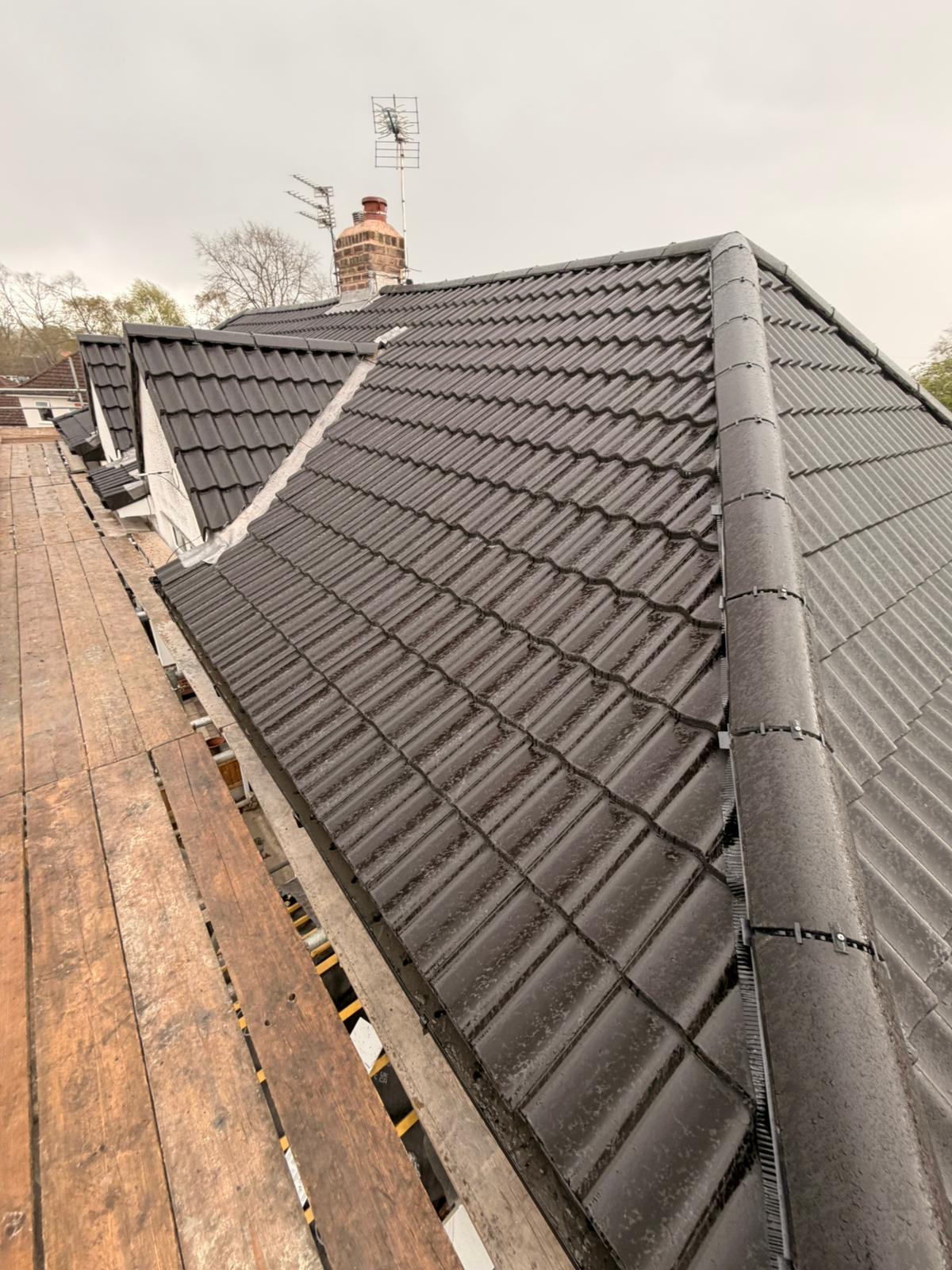 Newly installed dark grey tiled roof