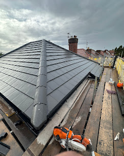 Hipped slate roof with new ridge tiles